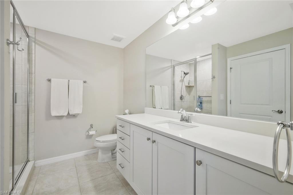 Bathroom with vanity, a shower stall, and light tile patterned flooring
