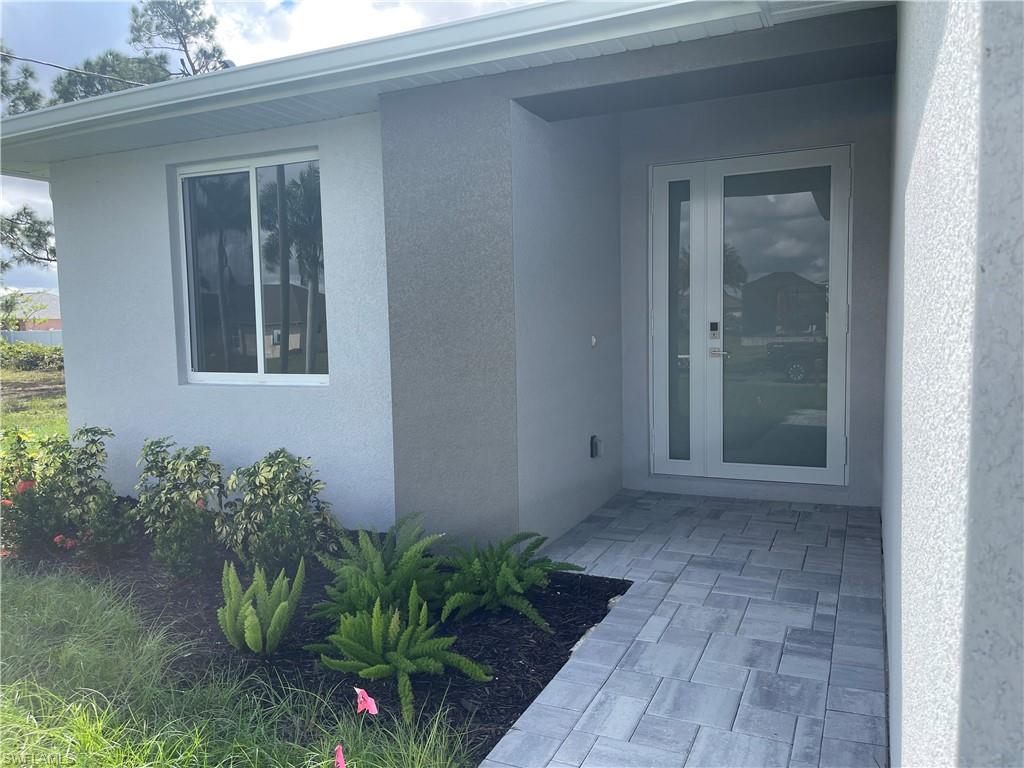 View of exterior entry with stucco siding