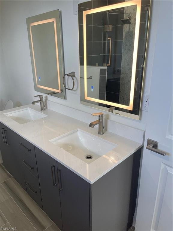 Full bath with double vanity and a stall shower