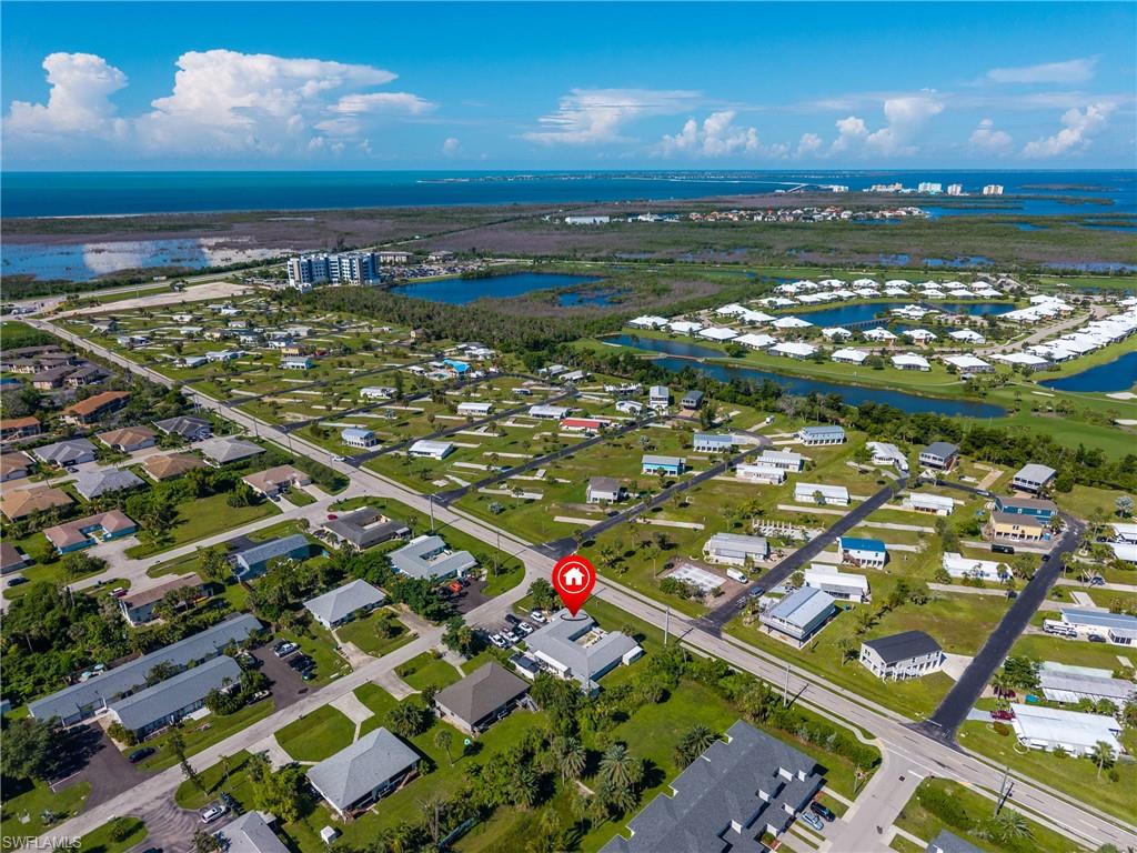 Aerial view of residential area featuring a large body of water