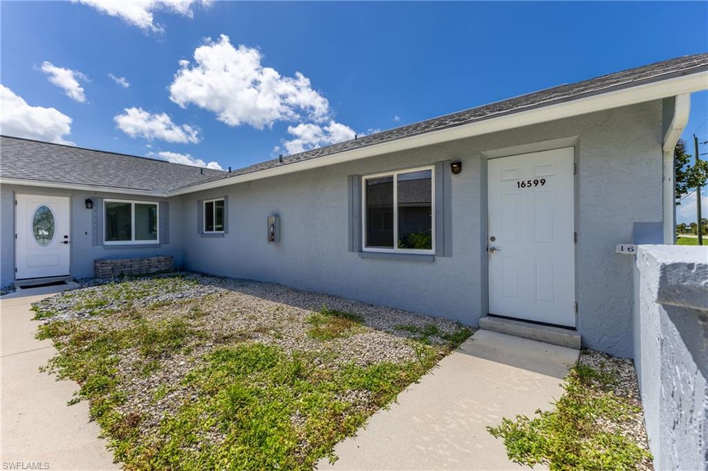 Entrance to property featuring stucco siding