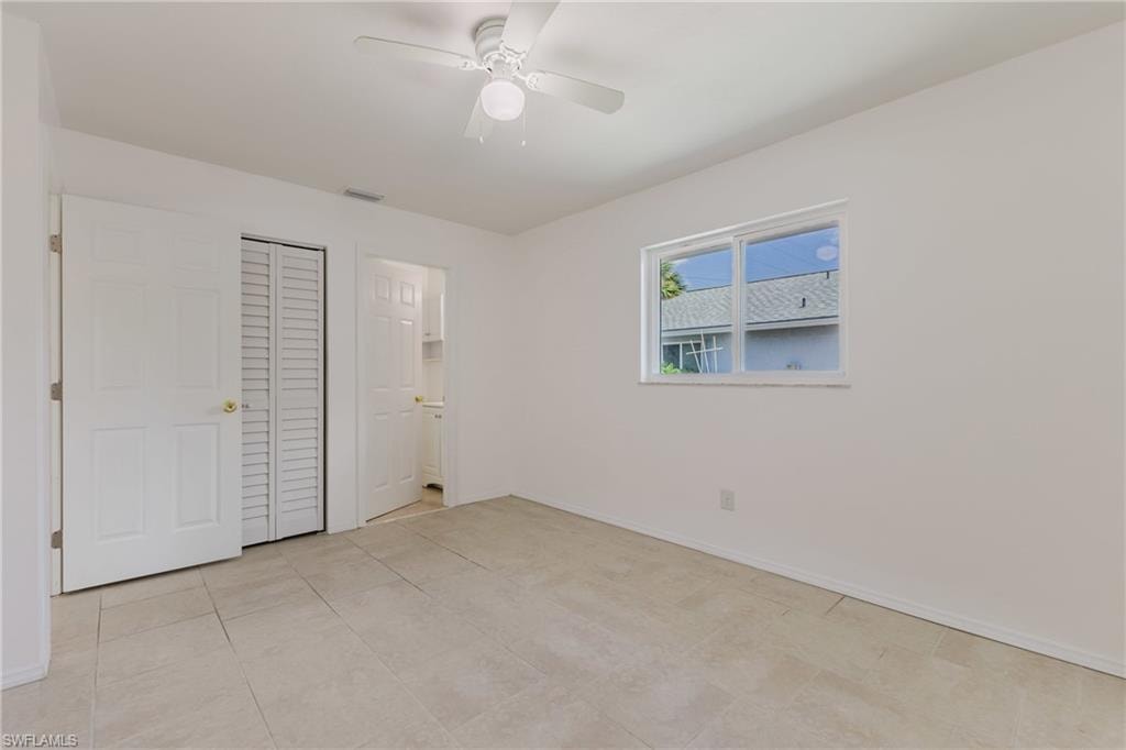 Unfurnished bedroom featuring ceiling fan and a closet