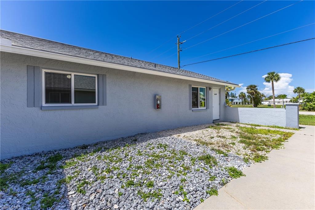 View of side of home featuring stucco siding
