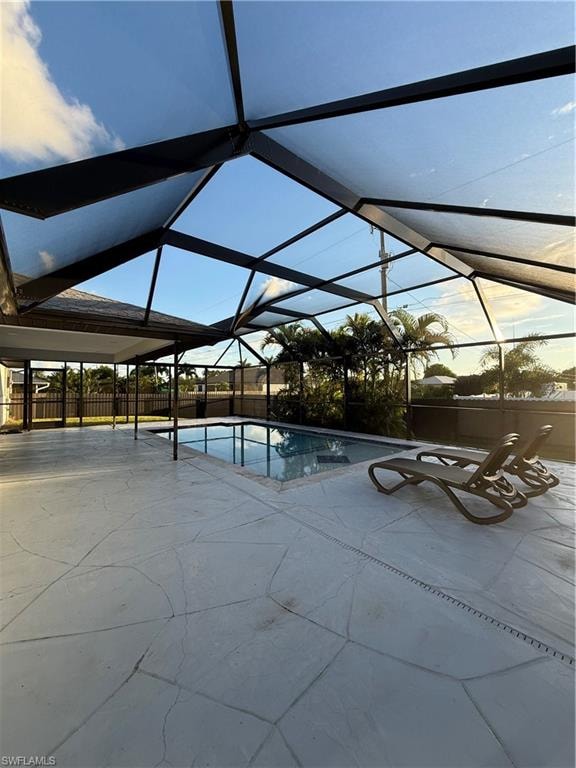 View of pool with a lanai, a sunroom, and a patio