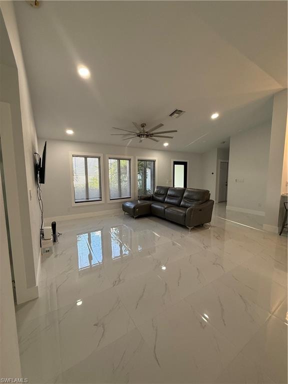 Living area with light marble finish flooring, recessed lighting, and a ceiling fan