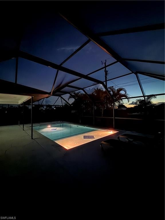 Outdoor pool featuring a lanai, a sunroom, a patio, and a hot tub