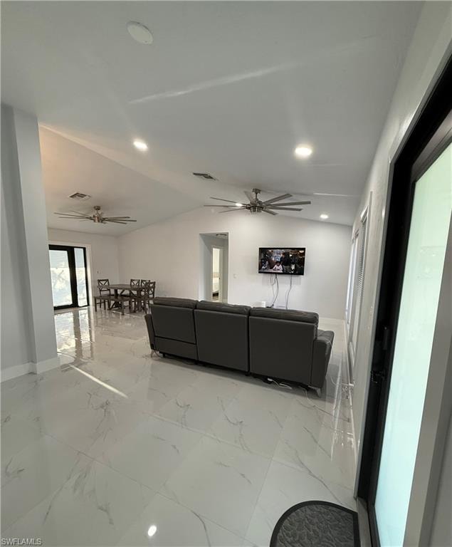 Living area with light marble finish floors, a ceiling fan, vaulted ceiling, and recessed lighting