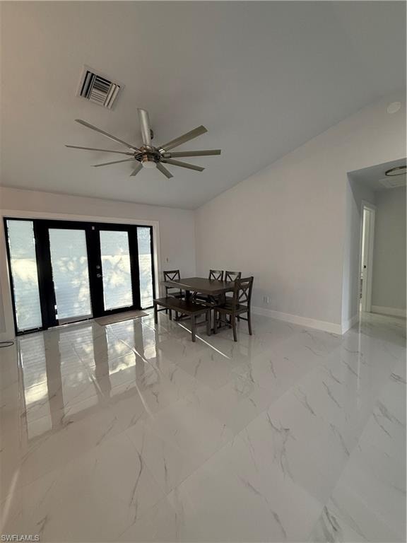Dining area with light marble finish floors and ceiling fan