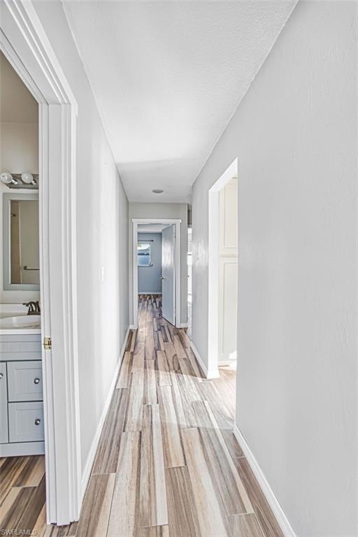 Hall featuring light wood-style floors