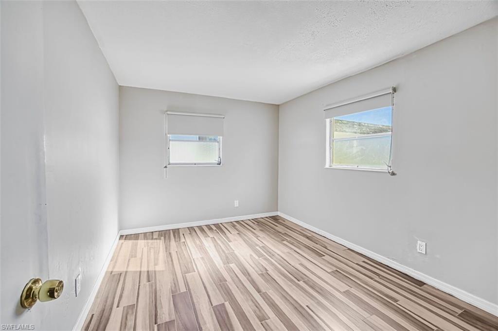Unfurnished room with light wood-style flooring and plenty of natural light