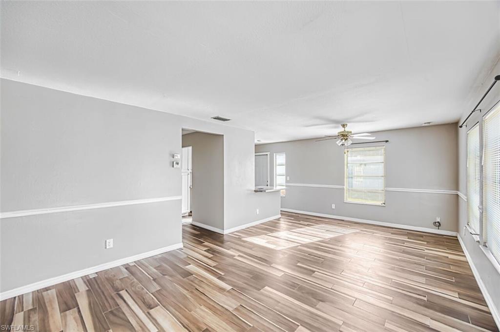 Empty room featuring wood tiled floors and a ceiling fan