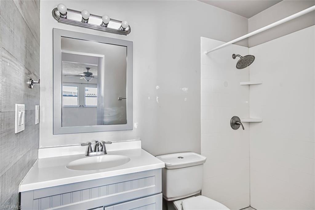 Bathroom featuring vanity and tiled shower