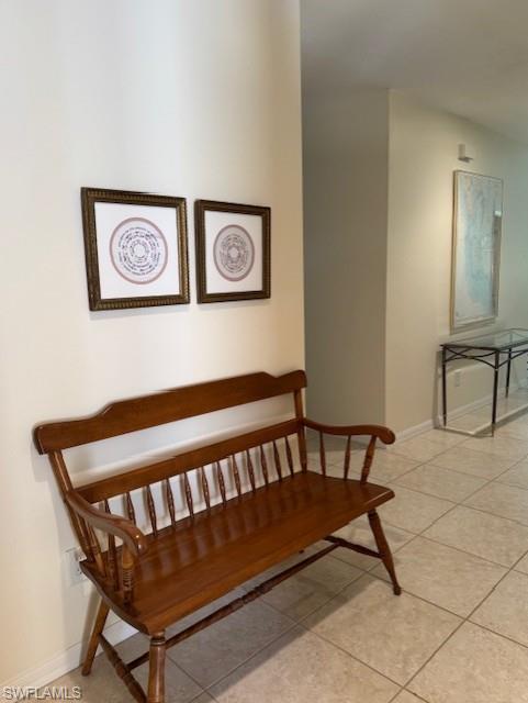 Stairway featuring baseboards and tile patterned floors