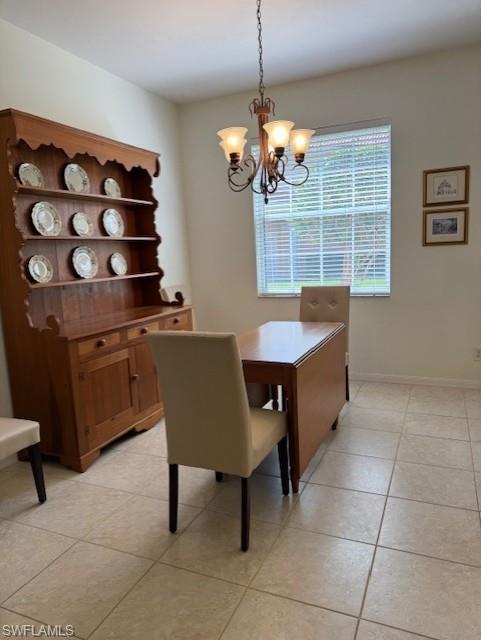 Dining room featuring light tile patterned flooring and hanging lights