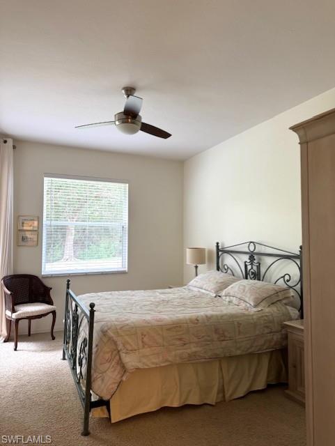 Carpeted bedroom with ceiling fan