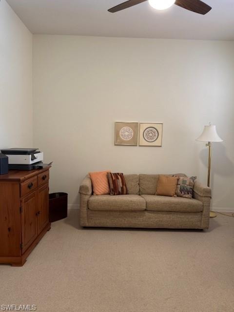 Living room with a ceiling fan and light colored carpet