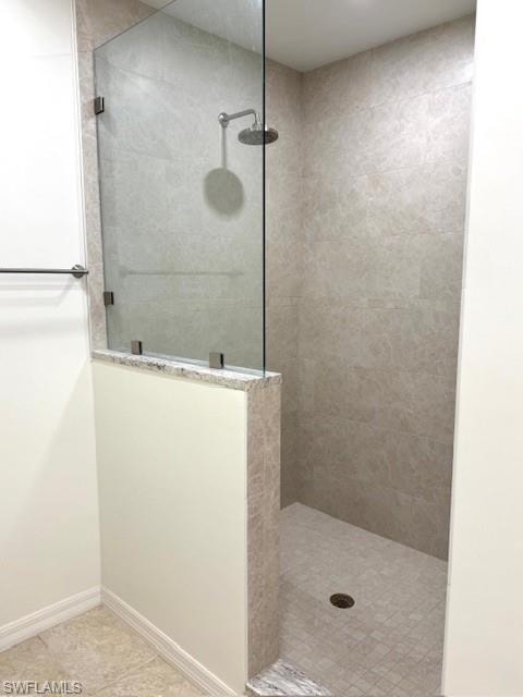 Bathroom featuring a walk in shower and light tile patterned floors