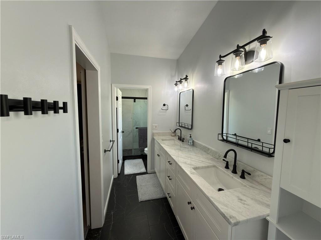 Bathroom with double vanity and a stall shower