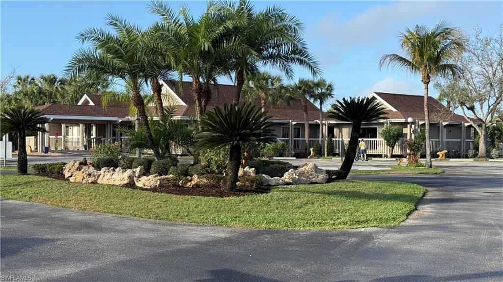 View of front facade with asphalt driveway