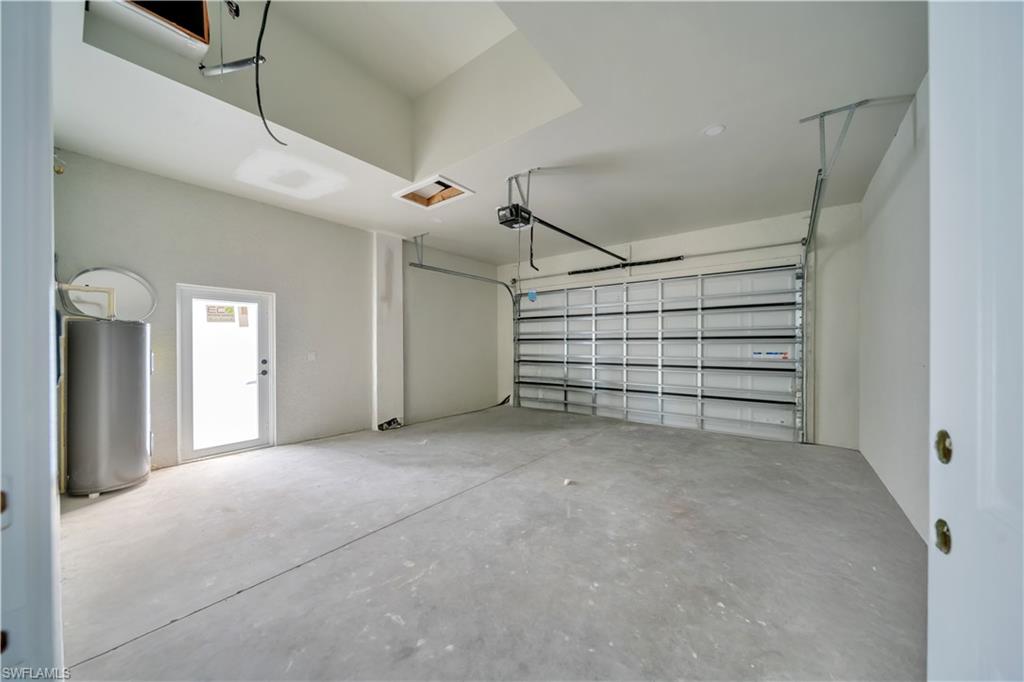 Garage with water heater and a garage door opener
