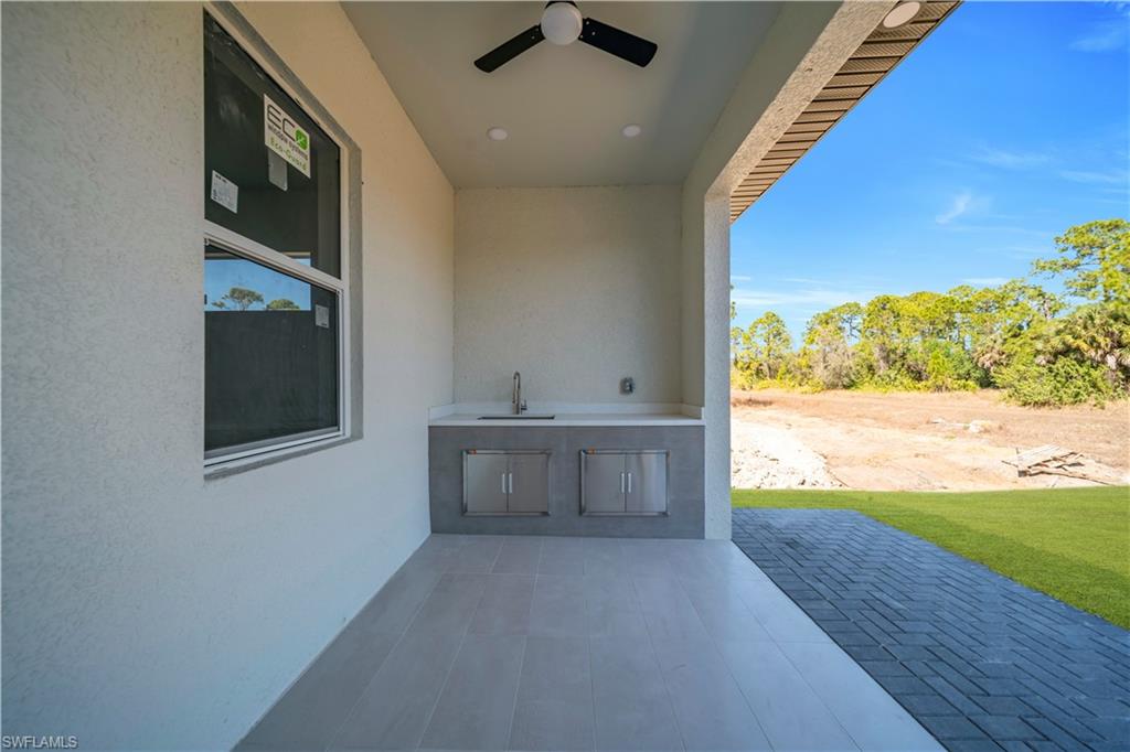 View of patio featuring ceiling fan and exterior kitchen