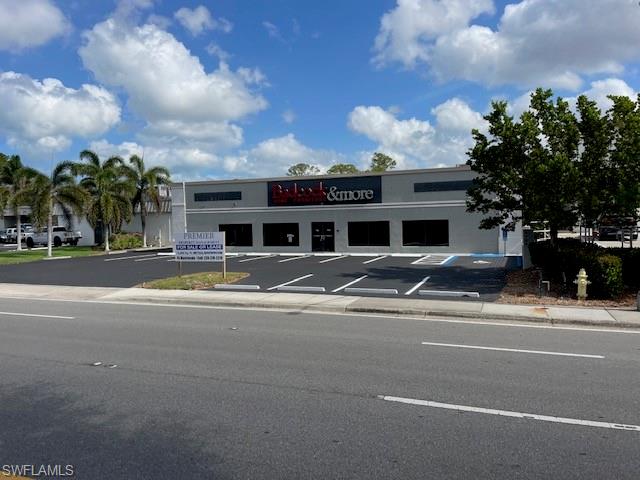 View of commercial location featuring uncovered parking