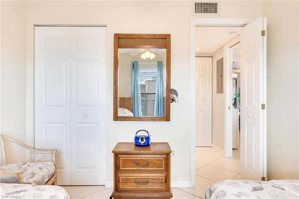 Bedroom featuring a closet and light tile patterned flooring