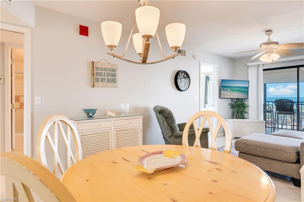 Tiled dining space with a ceiling fan
