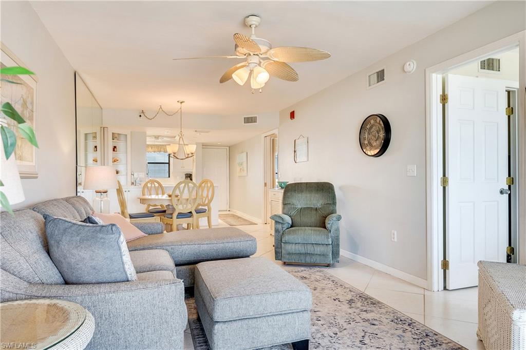 Living area with light tile patterned flooring and ceiling fan