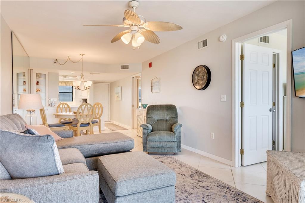 Living room featuring ceiling fan and light tile patterned flooring