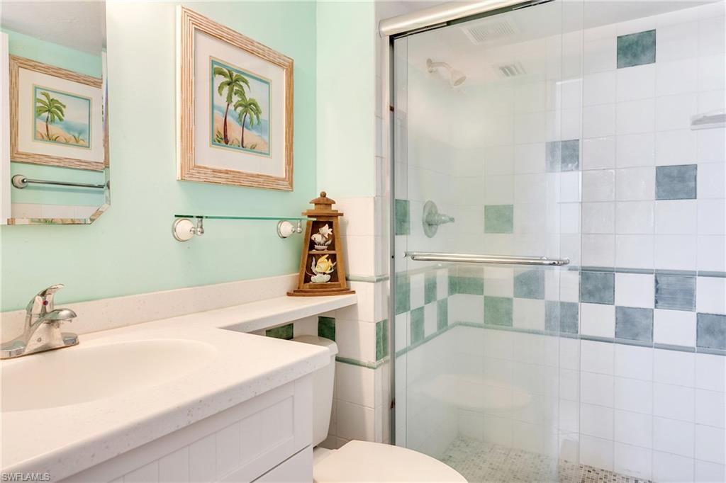 Full bathroom with a shower stall and vanity