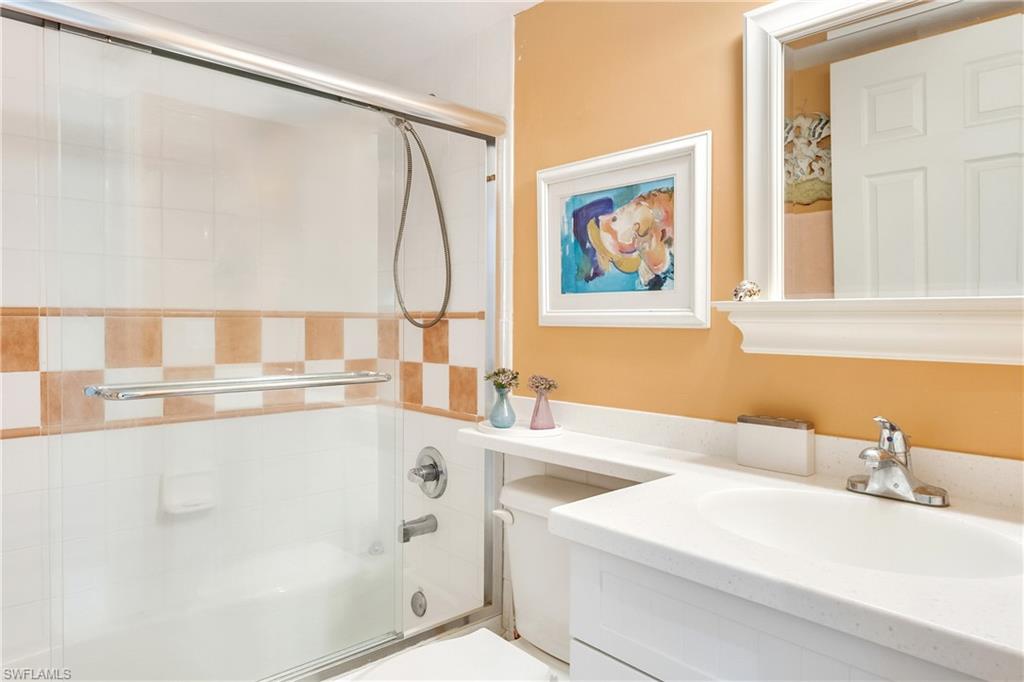 Bathroom with vanity and shower / bath combination with glass door
