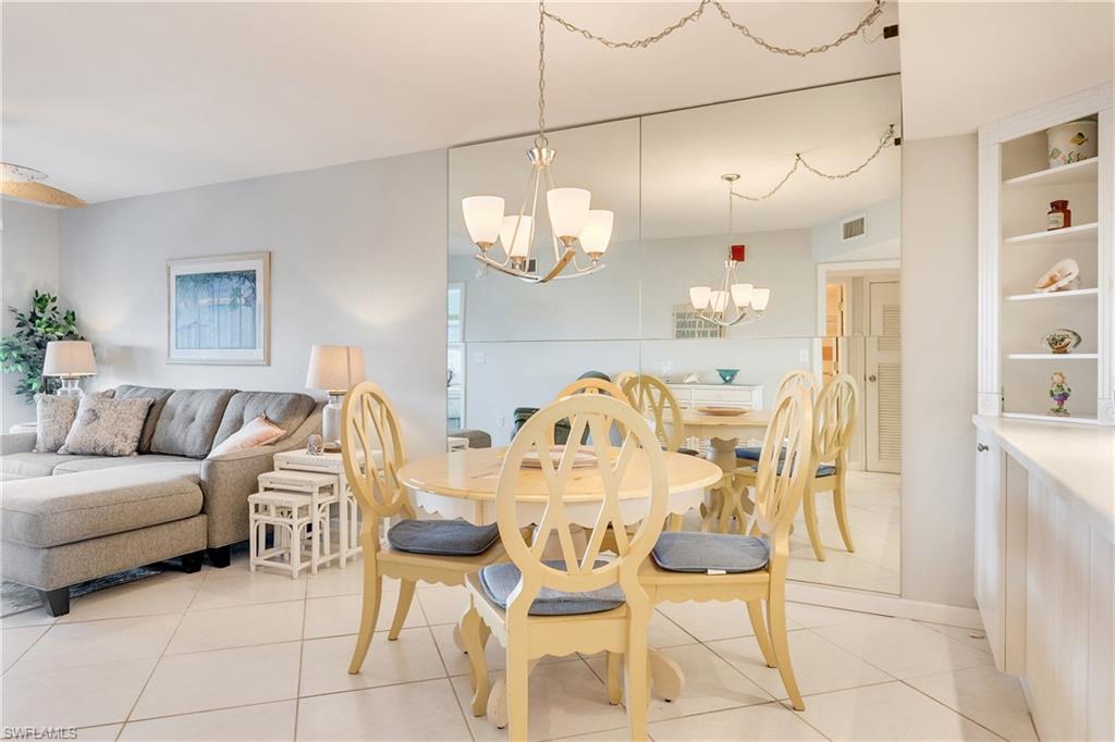 Dining room with a chandelier and light tile patterned floors