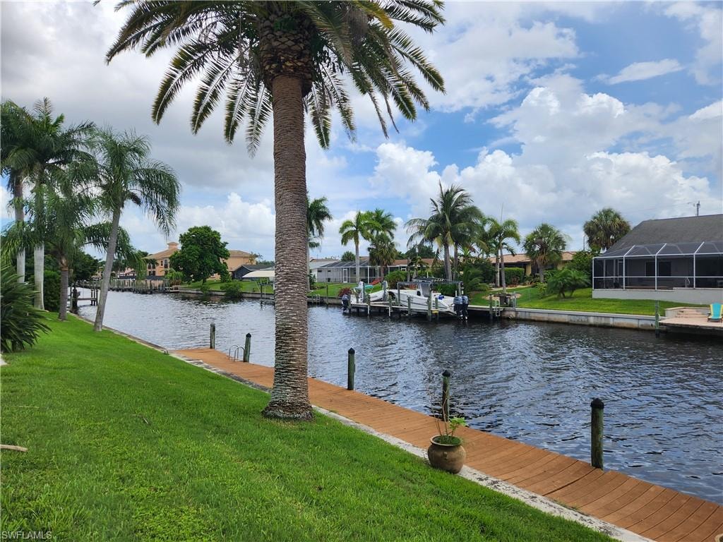 Dock area featuring a yard, a water view, and a residential view