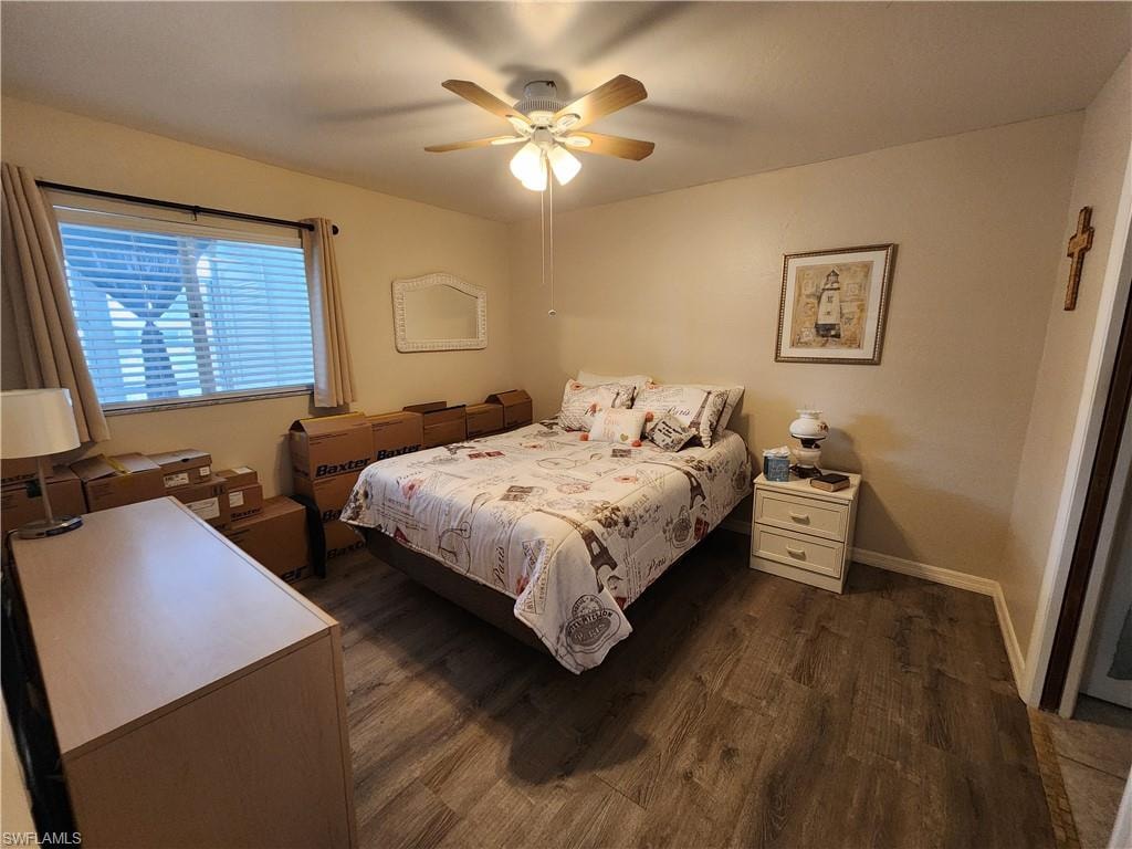 Bedroom featuring dark wood-style floors and a ceiling fan