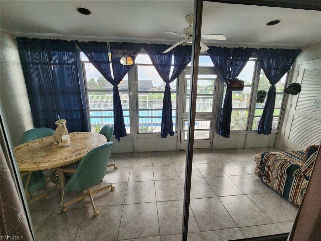 Dining room featuring ceiling fan and light tile patterned floors