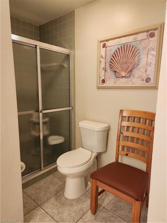 Full bathroom with a shower stall and light tile patterned floors