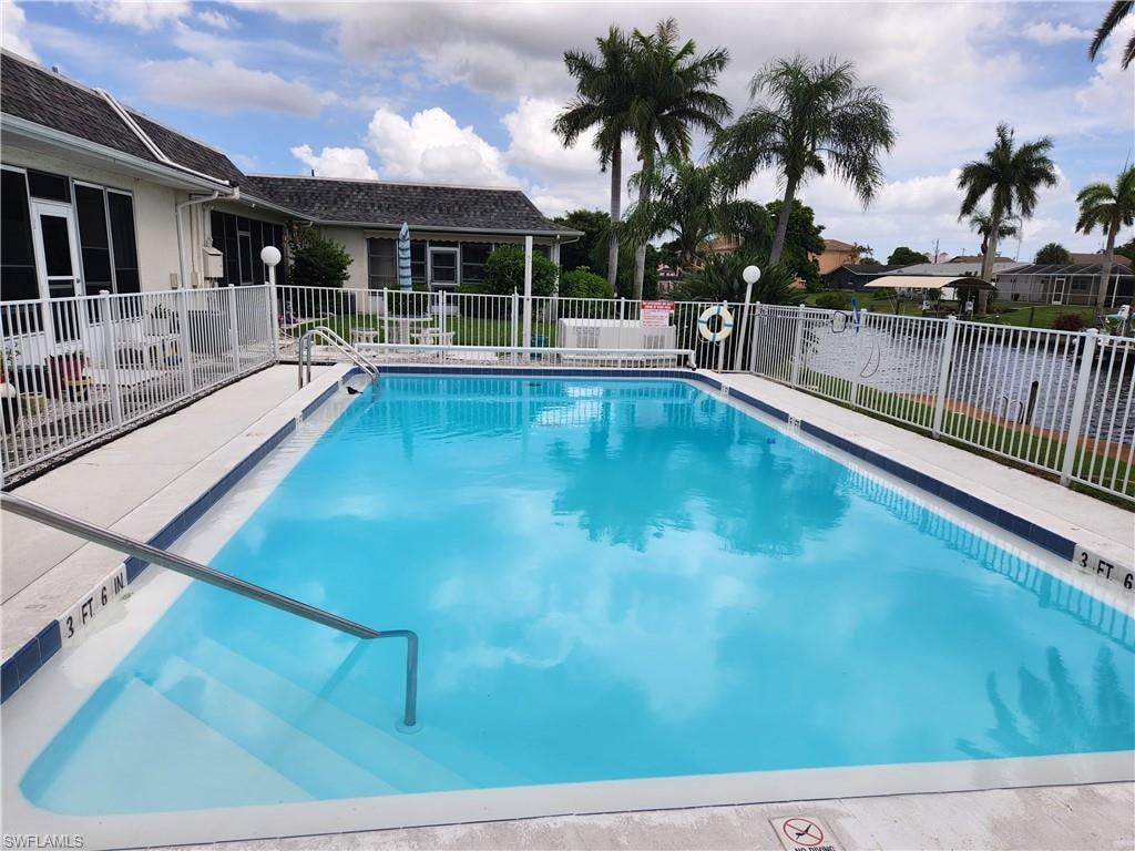 Community pool with a patio