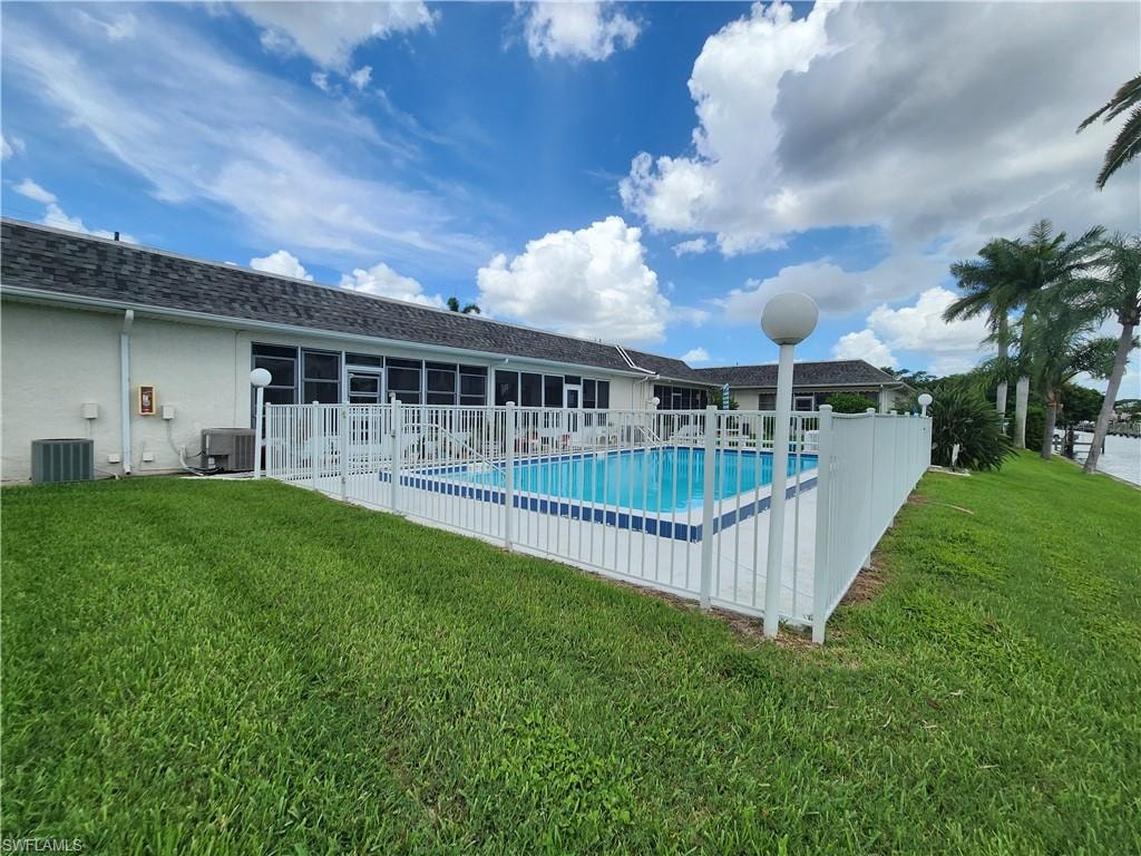 Community pool featuring a patio and a sunroom