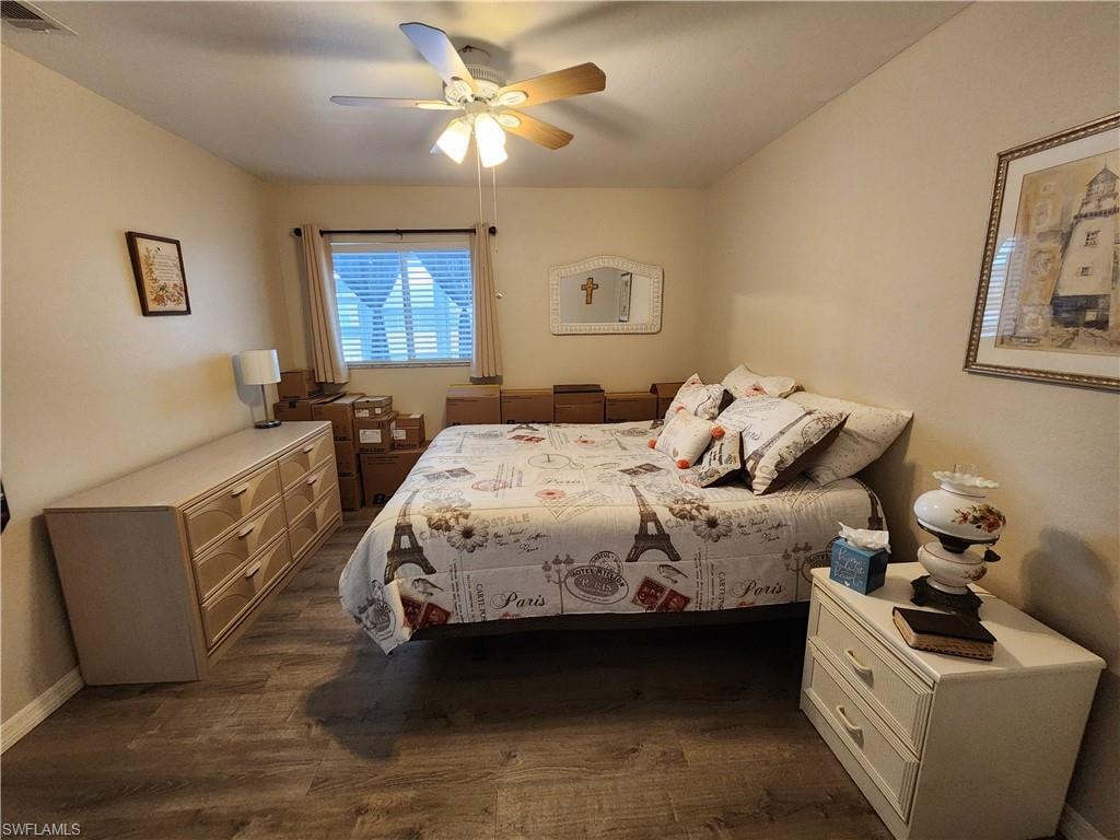 Bedroom featuring a ceiling fan and dark wood-style flooring