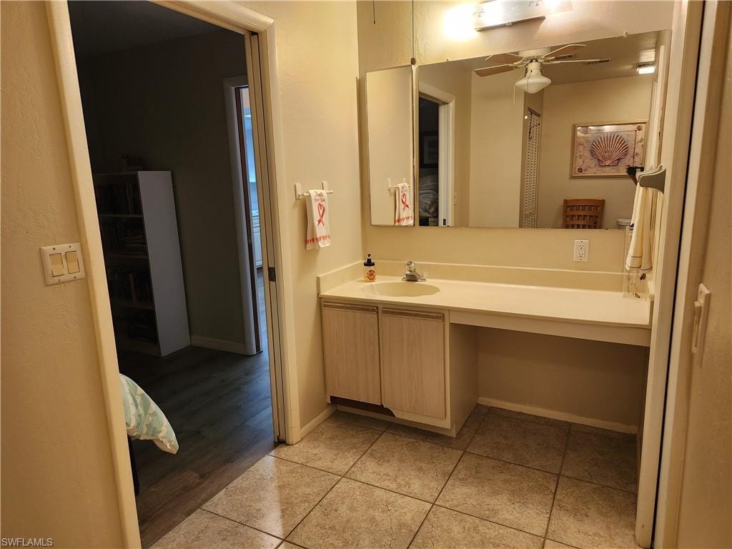 Bathroom with vanity, a ceiling fan, and light tile patterned floors
