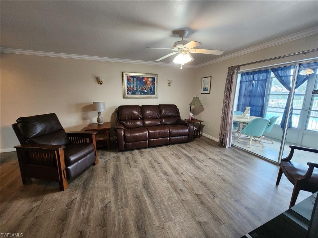 Living room featuring ceiling fan, wood finished floors, and crown molding