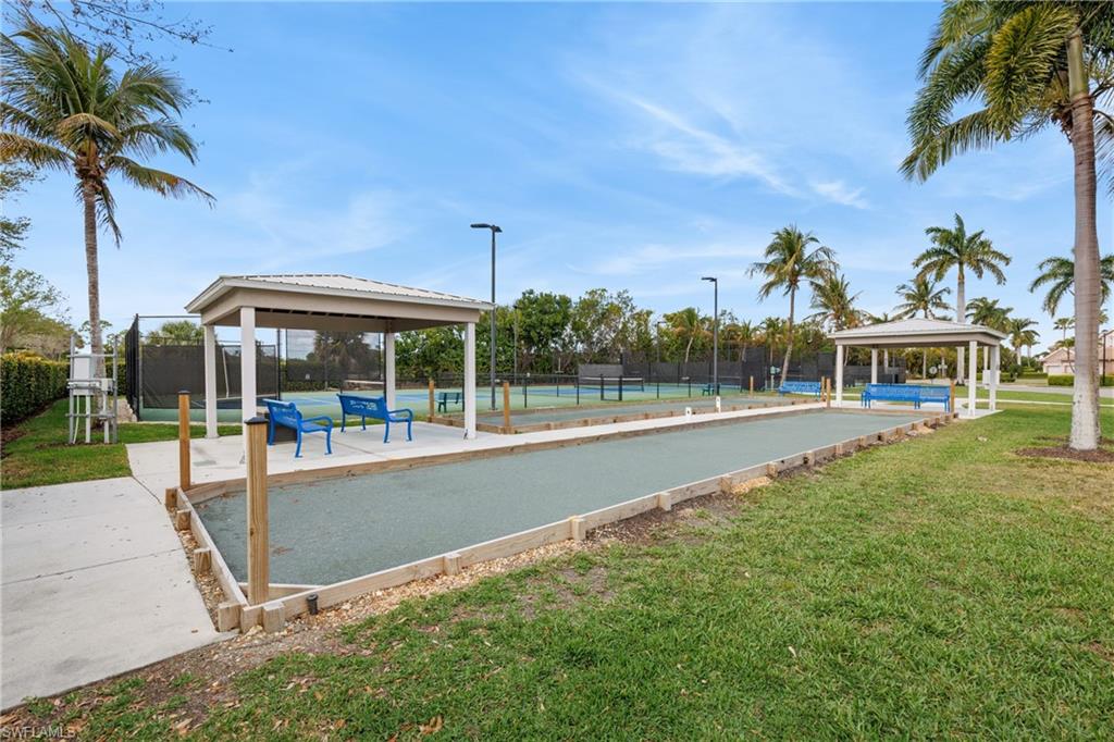 View of pool featuring a bocce ball area, a gazebo, and patio surround