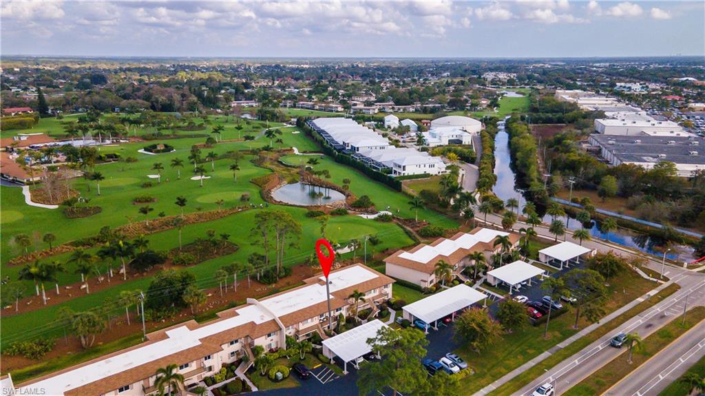 View of property location with a nearby body of water and a local golf course