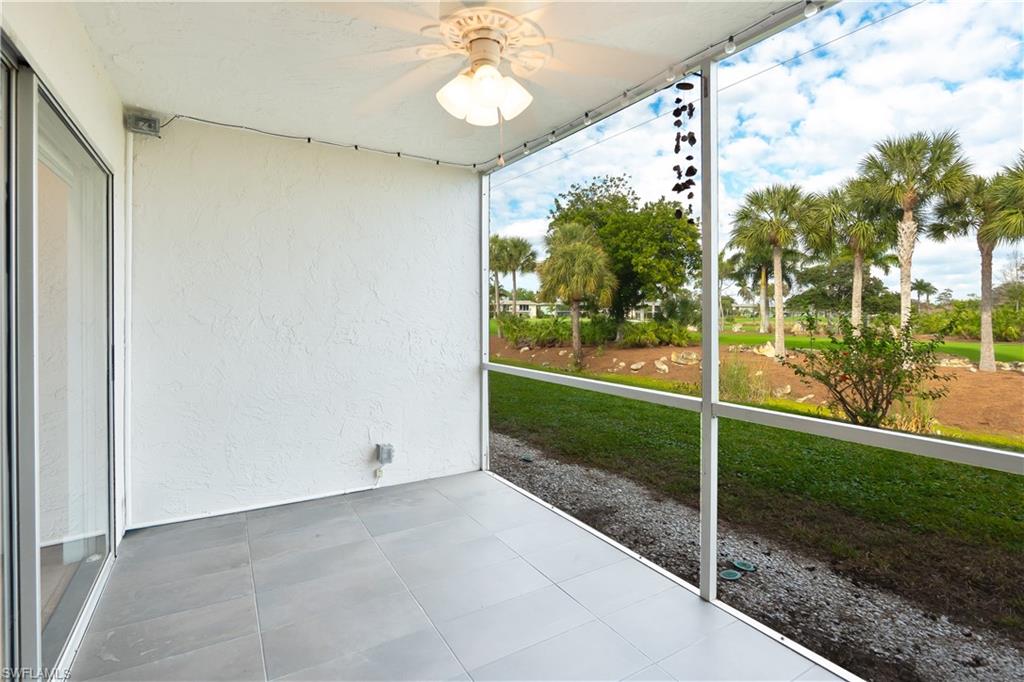 Unfurnished sunroom featuring ceiling fan