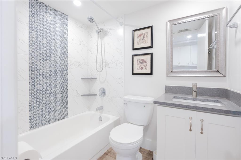 Bathroom with vanity, bathing tub / shower combination, and recessed lighting