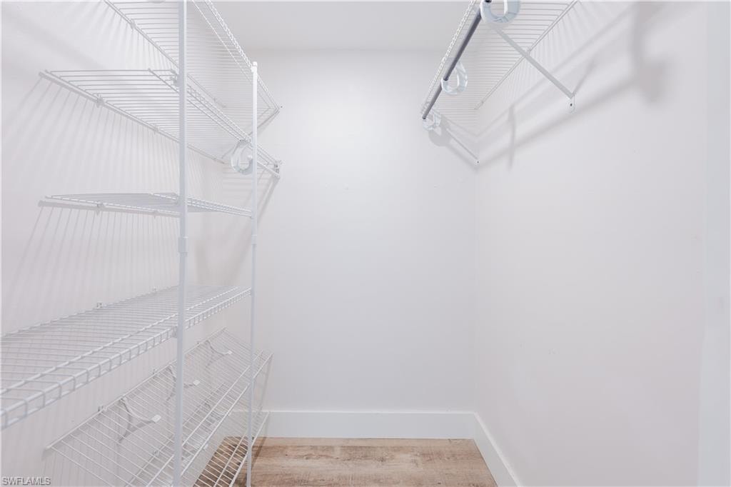 Walk in closet featuring light wood-type flooring