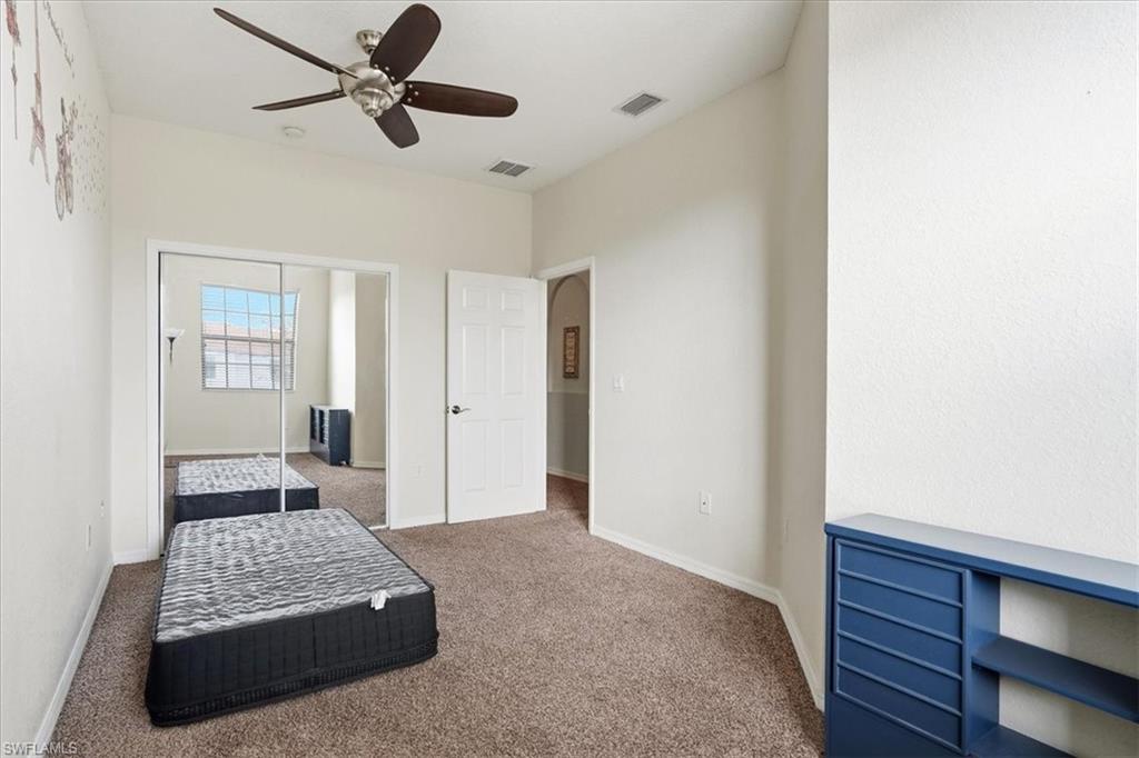 Bedroom featuring carpet, ceiling fan, and a closet