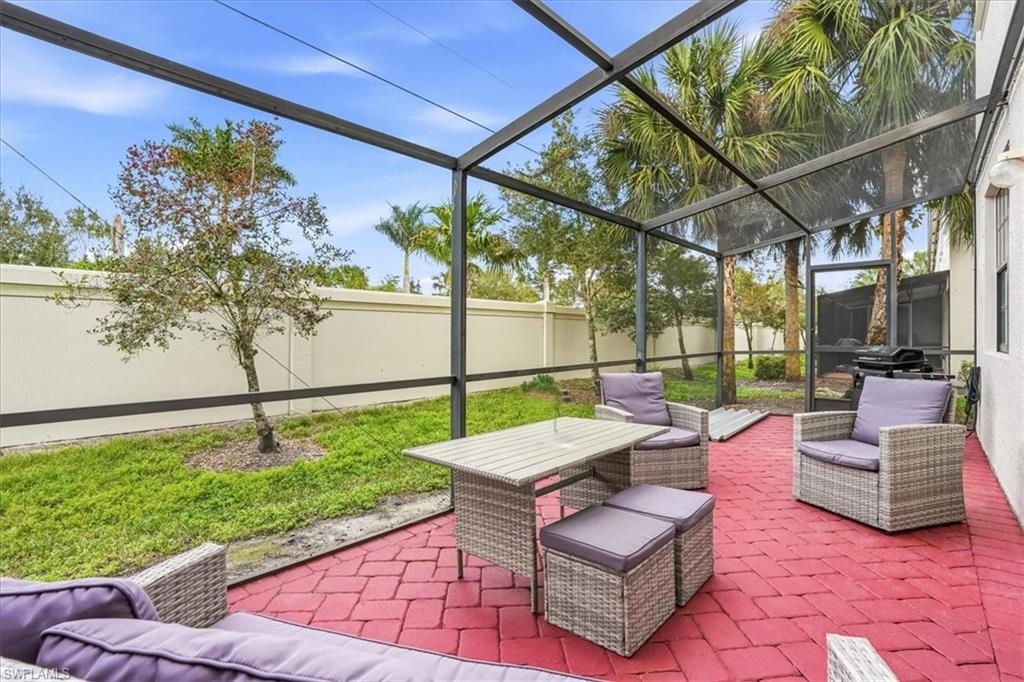 Fenced backyard with a patio area, a lanai, a sunroom, and outdoor dining space