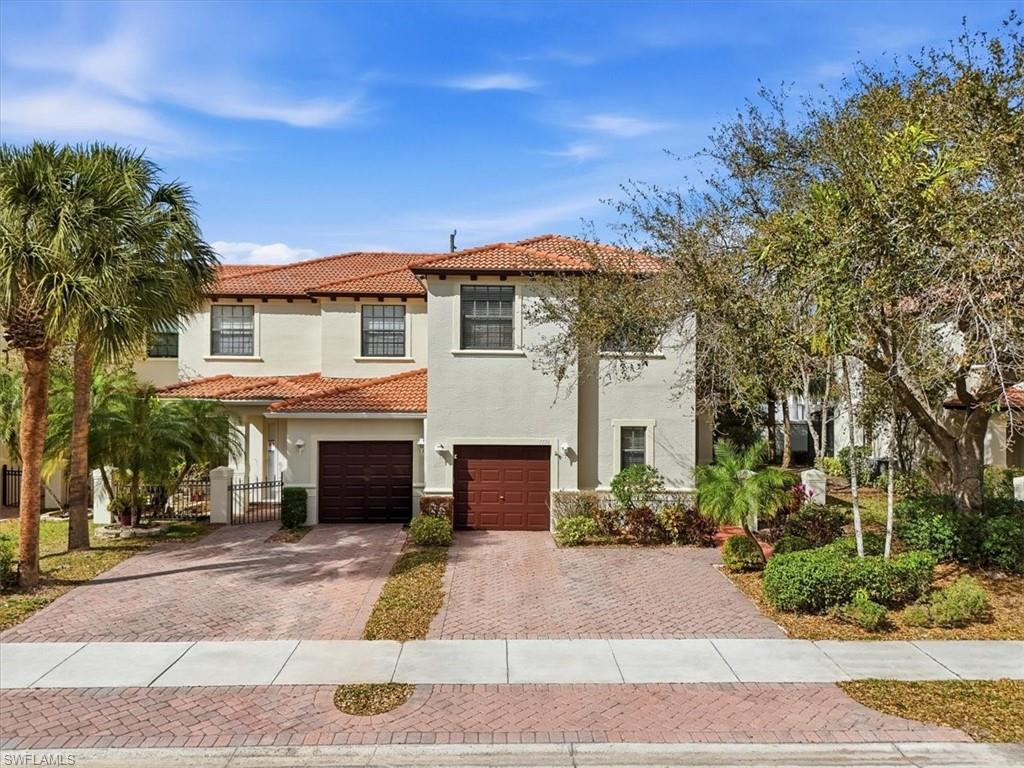 Mediterranean / spanish-style home featuring driveway, stucco siding, an attached garage, and a tile roof